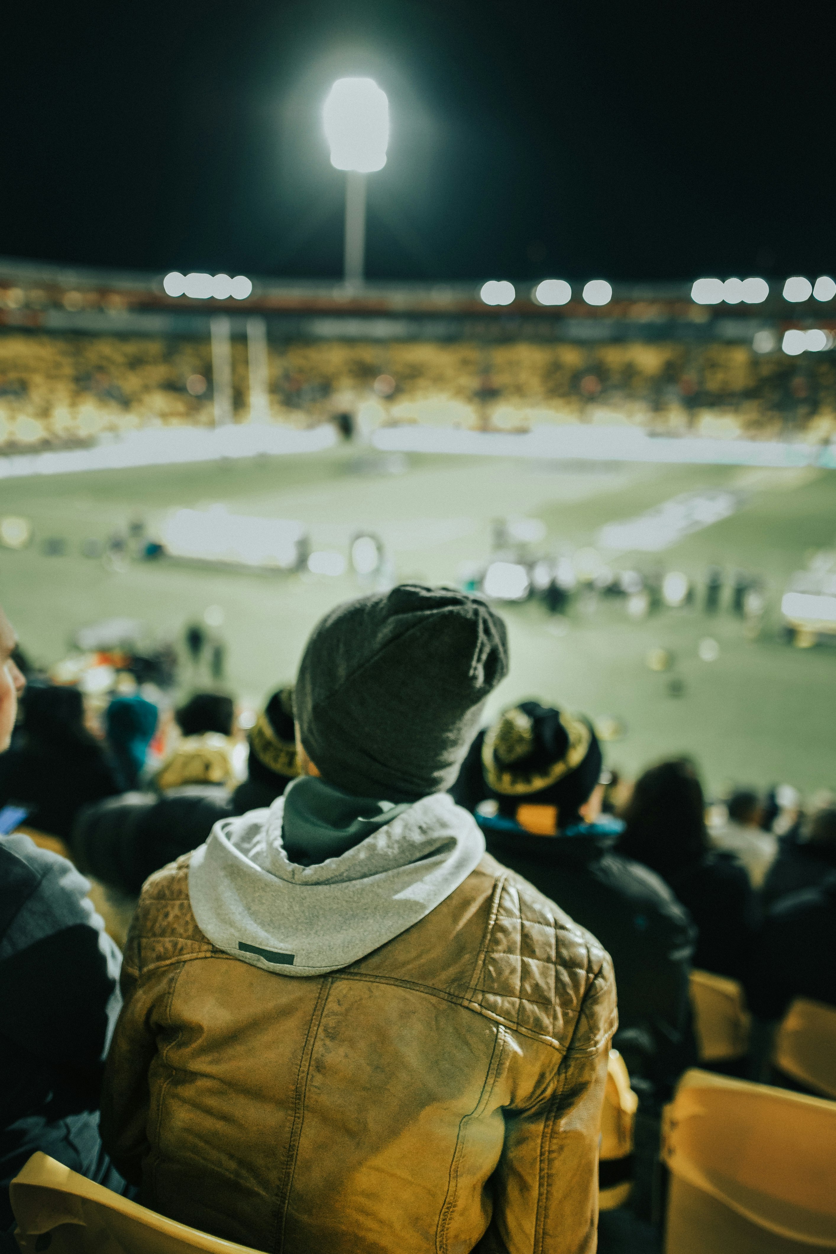 shallow focus photo of person in brown hoodie